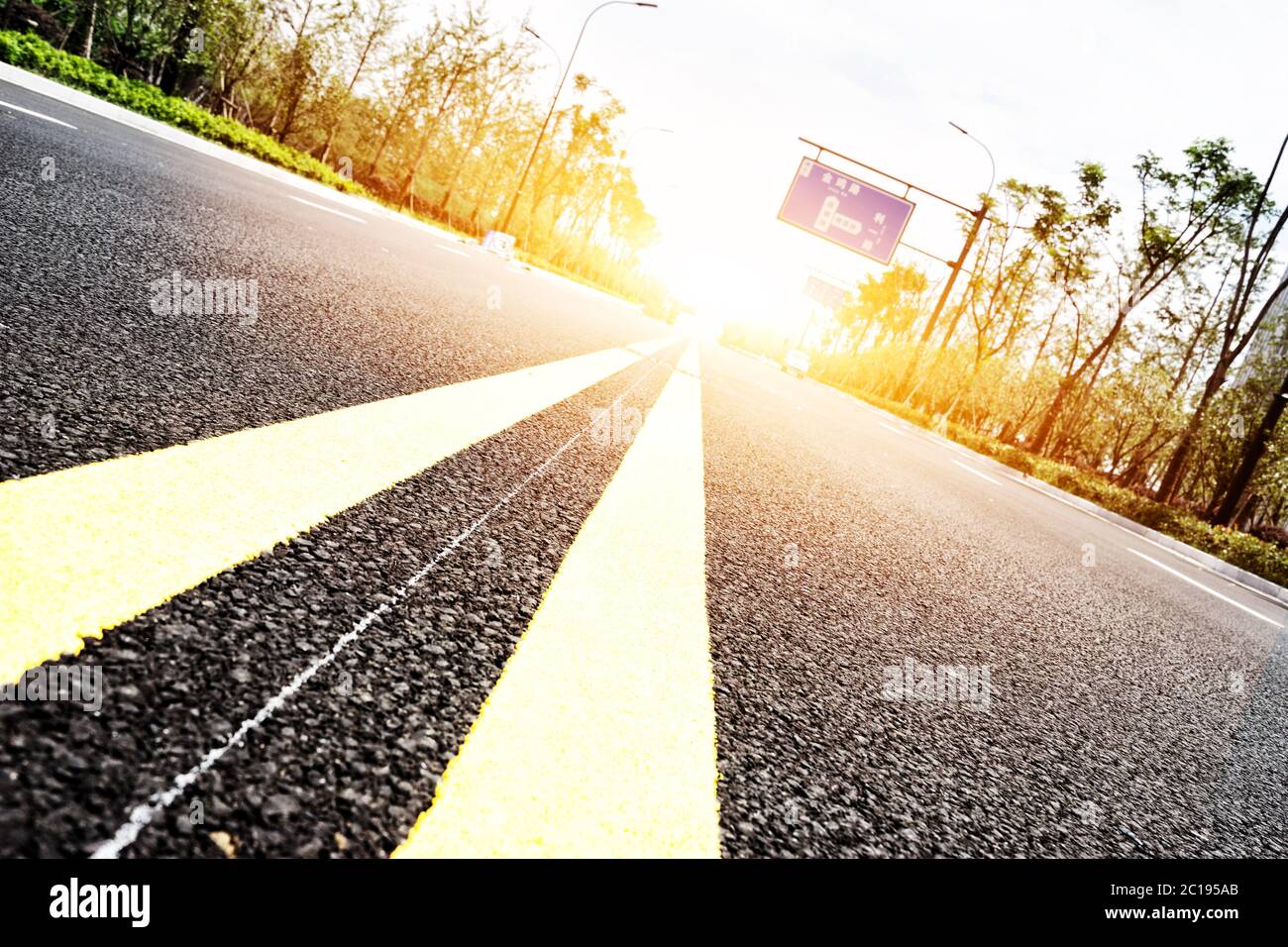 strada asfaltata di sobborgo vuota con fascio solare Foto Stock