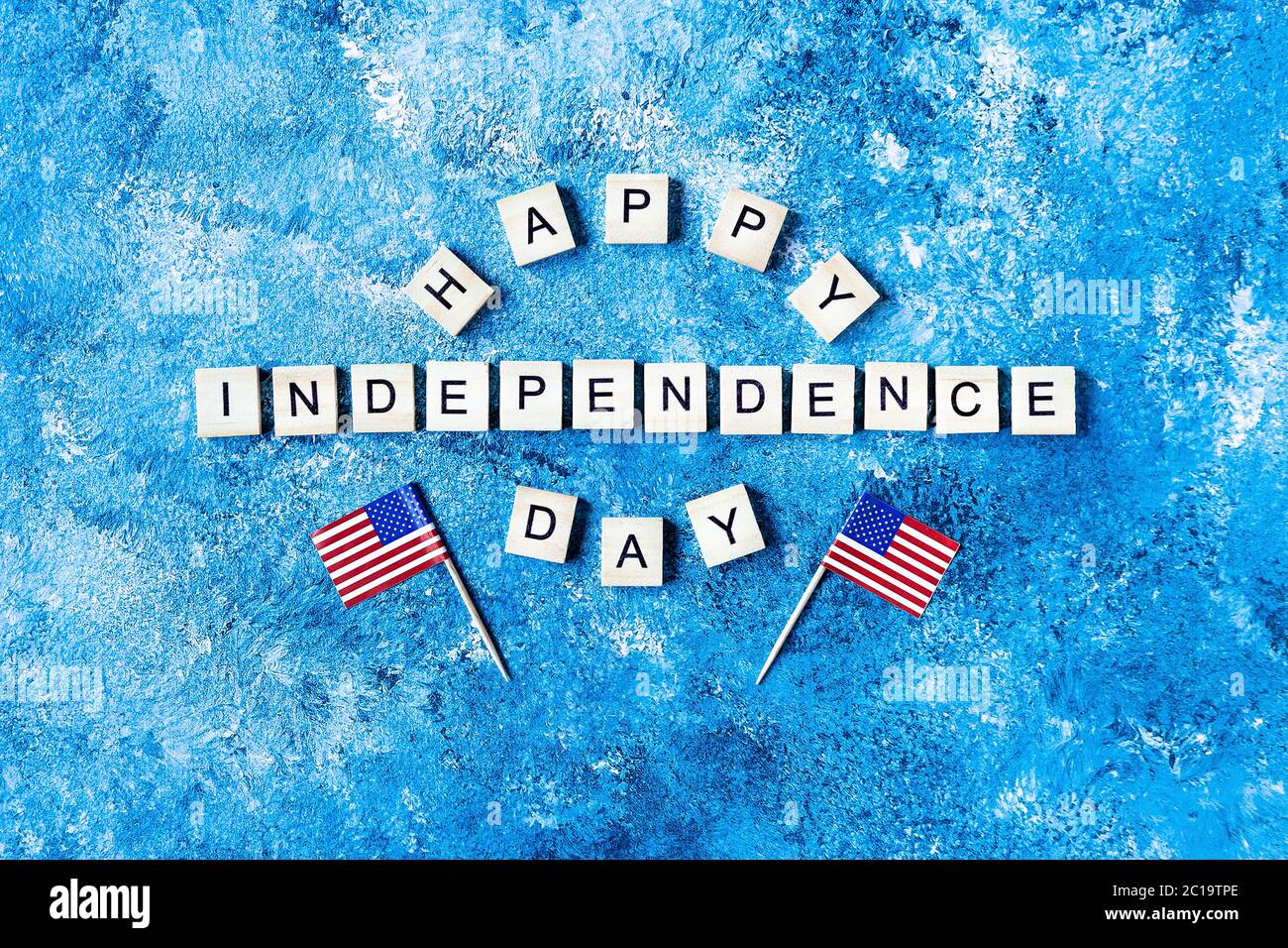 Independence Day iscrizione in lettere di legno su sfondo blu. Buon giorno di Indipendenza. Il 4 luglio. Giornata dell'indipendenza degli Stati Uniti. Bandiere americane. Co Foto Stock