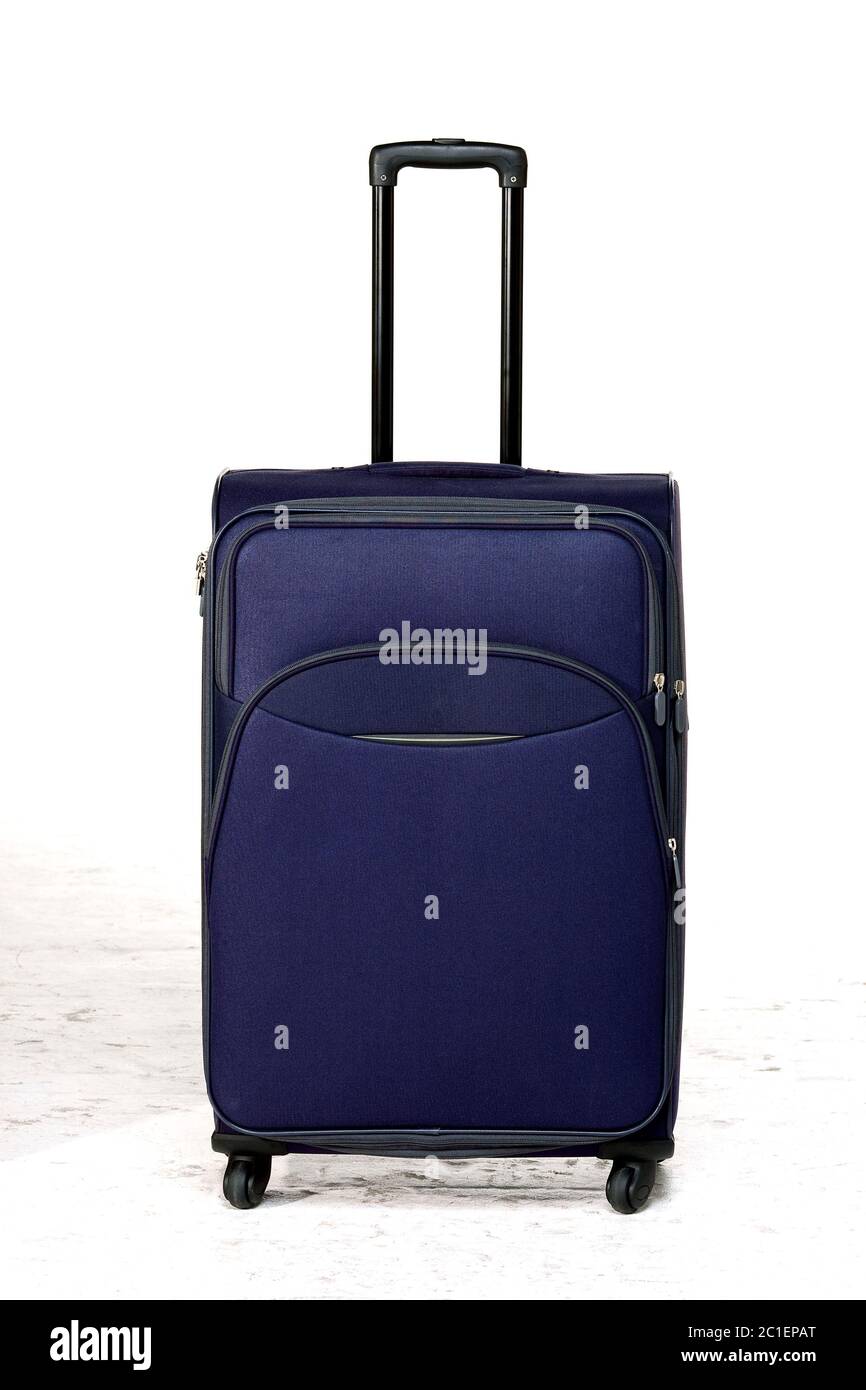 valigia blu su pavimento bianco Foto Stock
