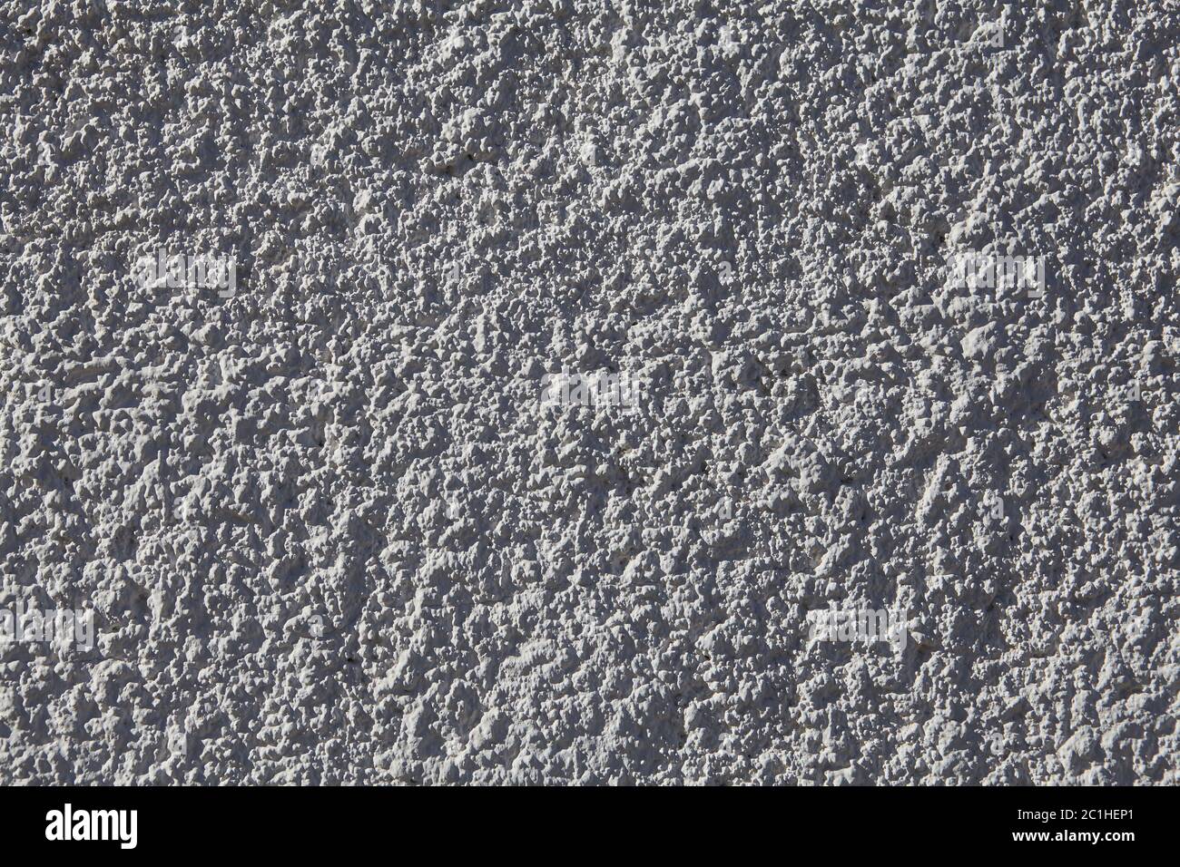 Struttura di parete intonacata grigia con intonaco granulare ruvido. Foto Stock