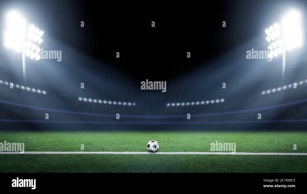 Tradizionale pallone da calcio illuminato dalle luci dello stadio Foto Stock