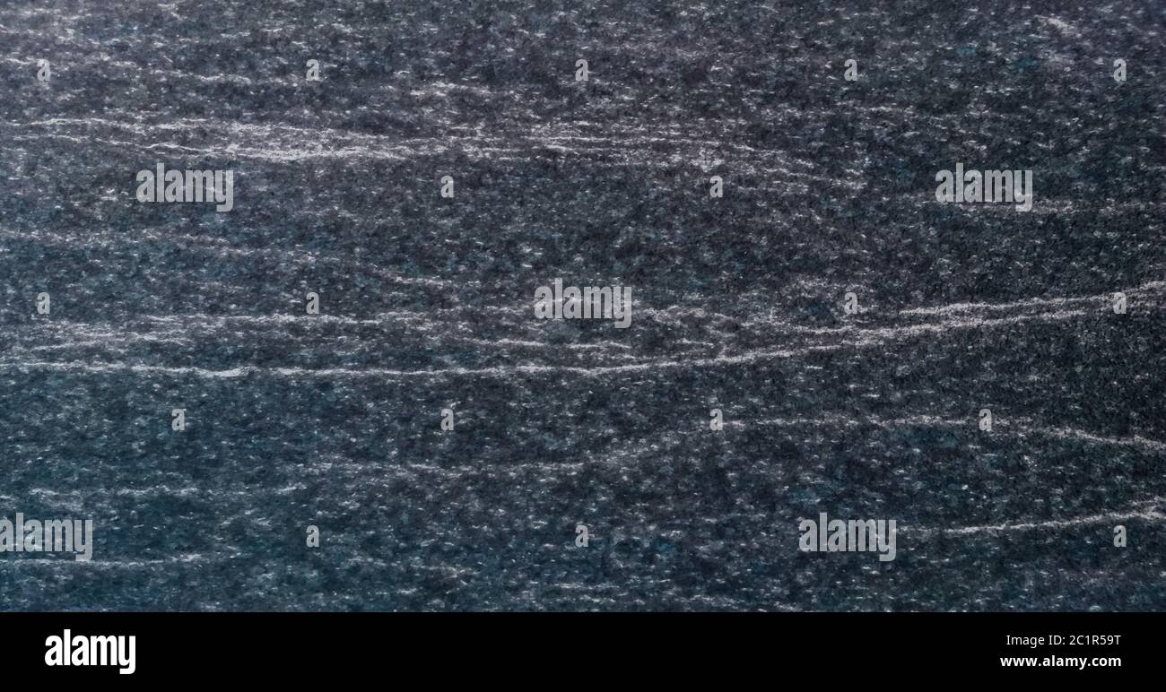 Texture e sfondo senza giunture di granito nero. Foto Stock