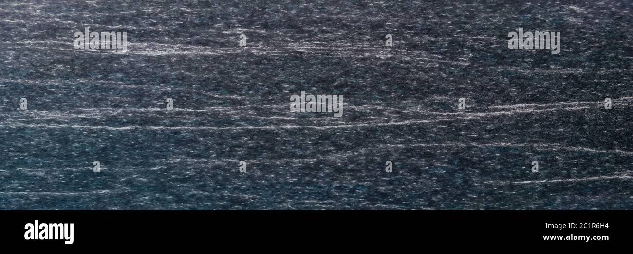 Texture e sfondo senza giunture di granito nero. Foto Stock