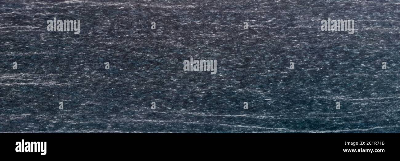 Texture e sfondo senza giunture di granito nero. Foto Stock