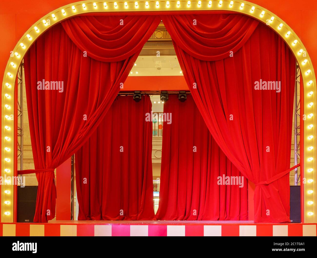 Palco con tende rosse e faretti. Scena teatrale alla luce dei proiettori, l'interno del vecchio teatro. Foto Stock