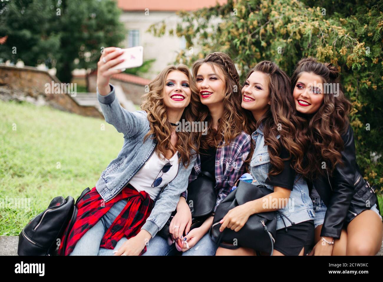 Moda donna con capelli tenendo selfie all'esterno. Foto Stock