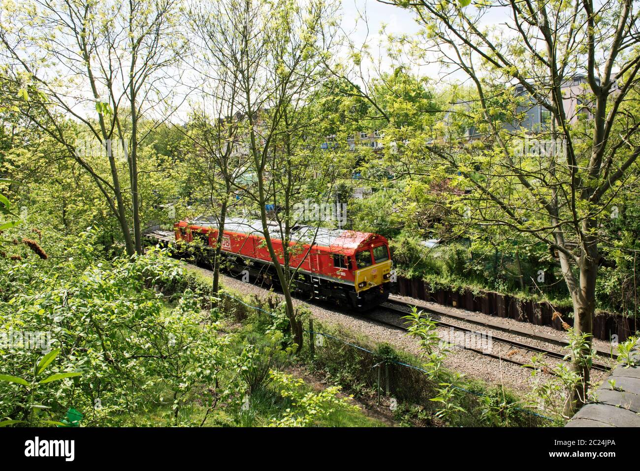 Treno merci sulla sezione curva di Canonbury della linea ferroviaria poco prima di passare Drayton Park Station Foto Stock