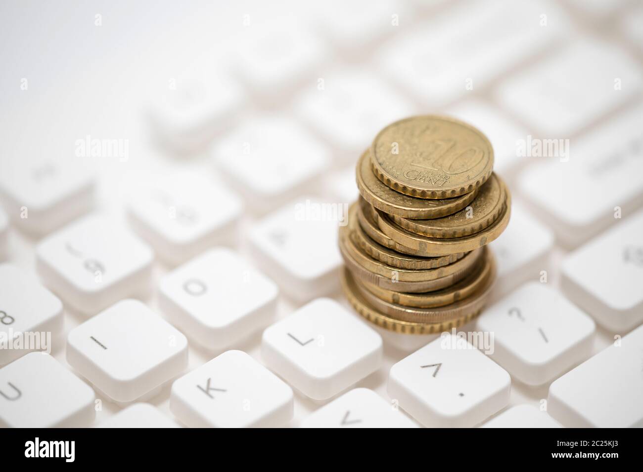 Monete metalliche in euro sulla tastiera del computer Foto Stock