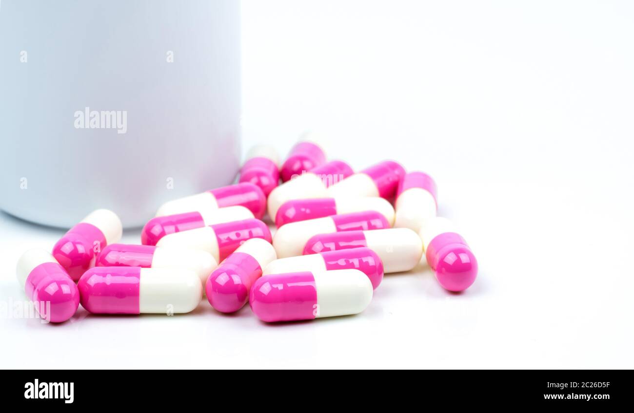 Colorful di pillole di capsule di antibiotico con flacone di plastica isolato su sfondo bianco con spazio di copia. Resistenza ai farmaci, uso di antibiotici con reas Foto Stock