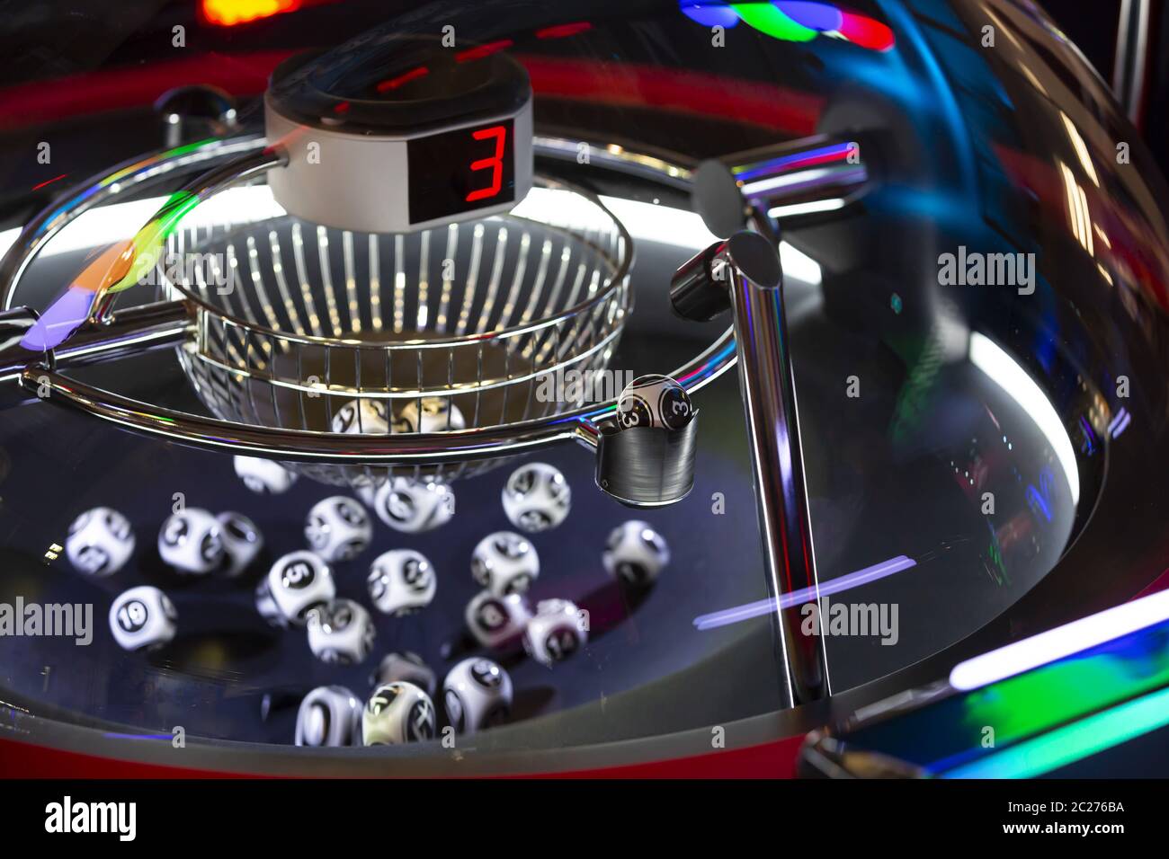 Palline di lotteria bianche e nere in una macchina di bingo rotante. Numero 3 Foto Stock