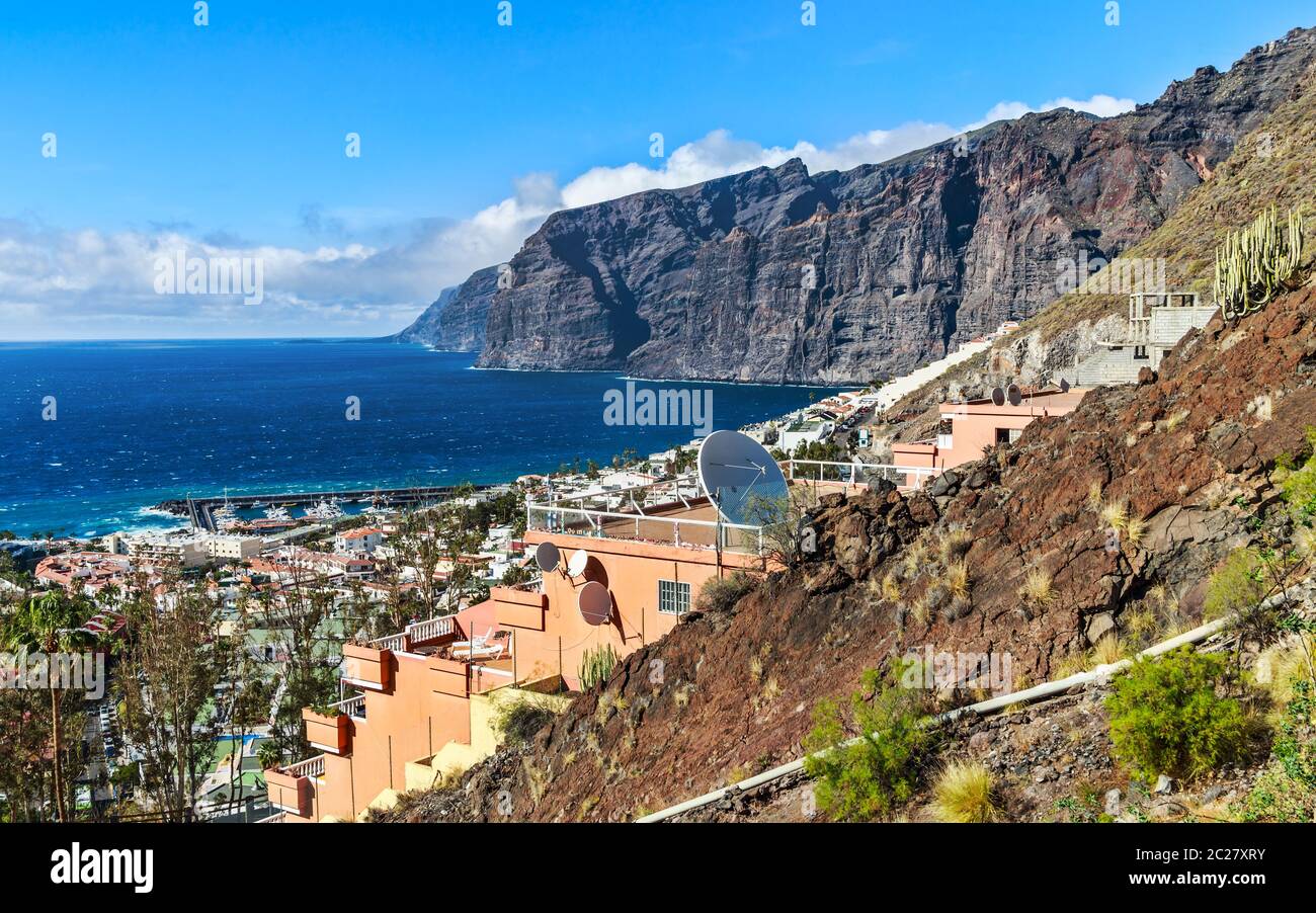 Il popolare resort Los Gigantes sulla costa nord-occidentale dell'isola di Tenerife, circondato dalle enormi scogliere basaltiche di Acantilado de Los Gigantes. Foto Stock