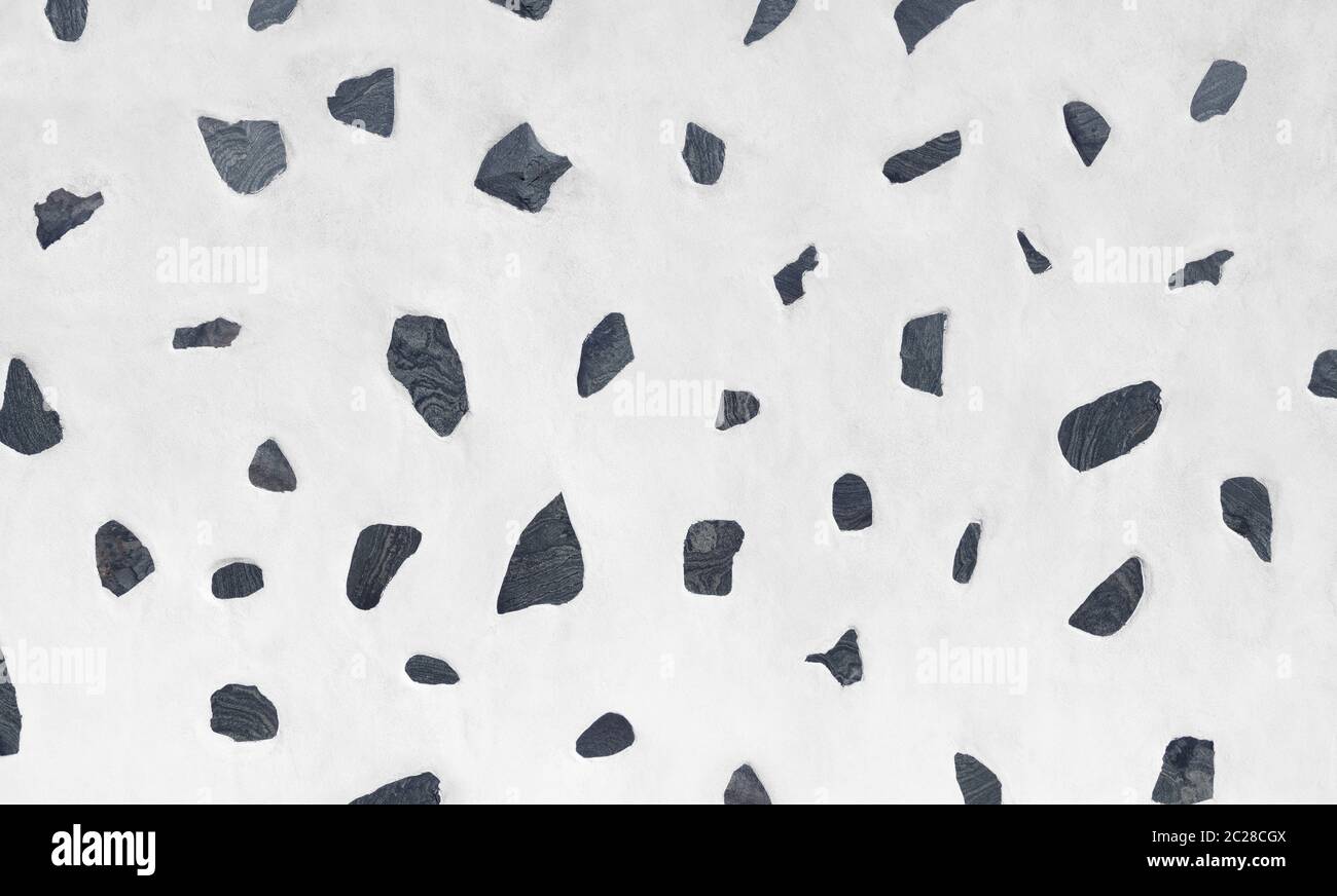 Parete bianca con motivo di pietre laviche grigie, design tipico delle Isole Canarie, Spagna Foto Stock