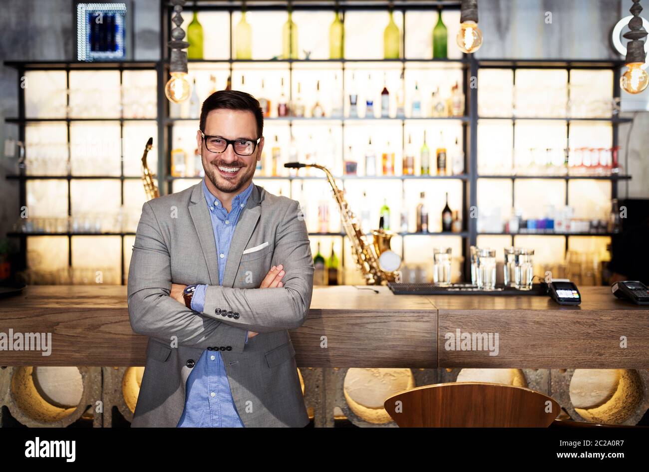 Giovane uomo imprenditore in piedi in nuovo locale. Startup, imprenditore, concetto di business. Foto Stock