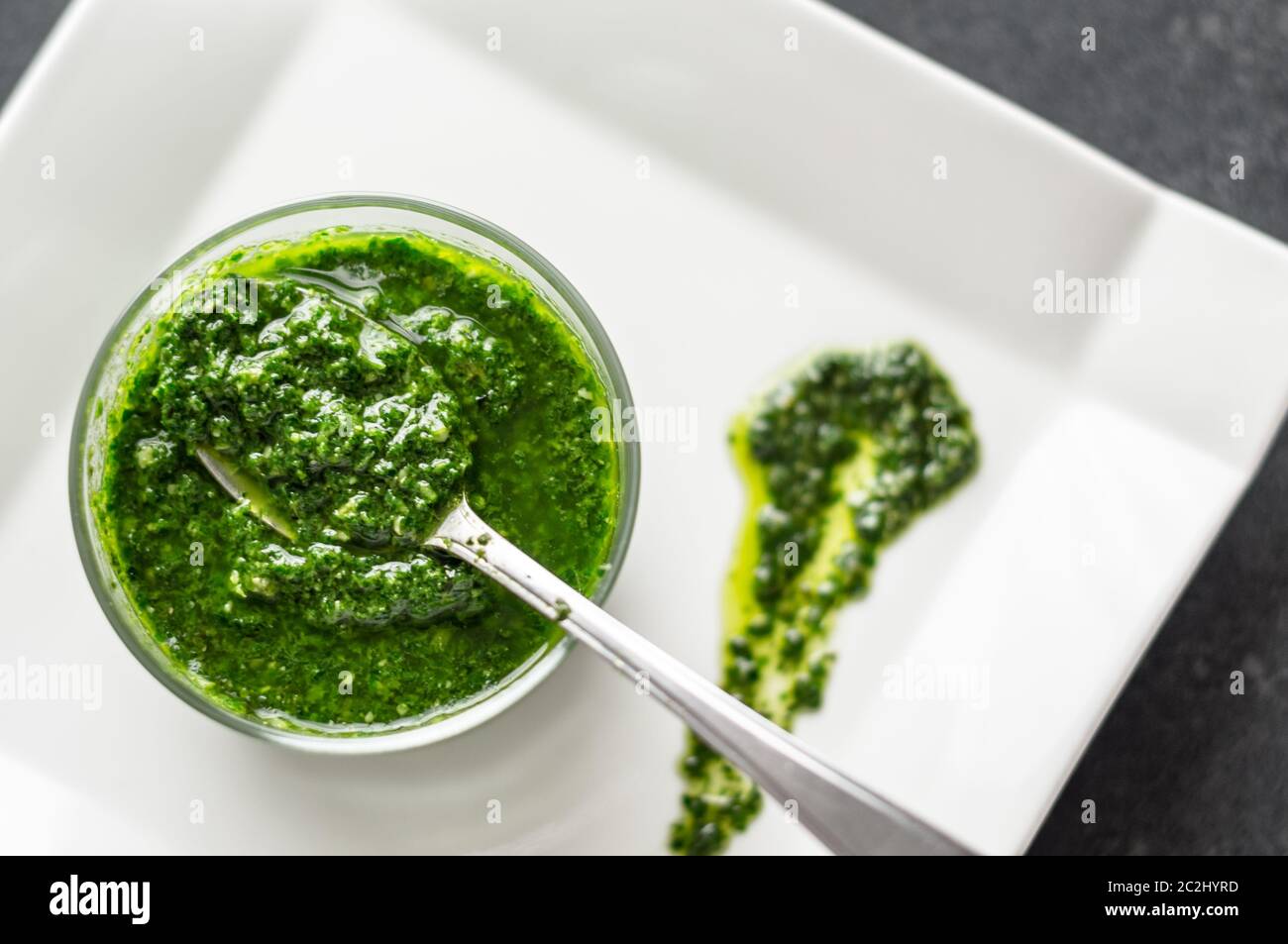Salsa di pesto di basilico fresco fatto in casa in un vaso di vetro. Originario dell'italia, il pesto è comunemente fatto con basilico e utilizzato come salsa per la pasta. Foto Stock