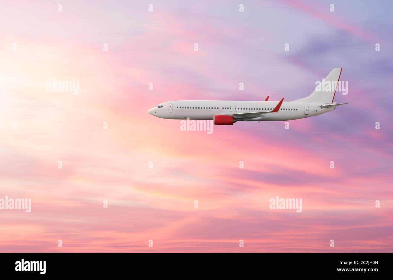 Piano aereo nel cielo in Cielo di tramonto Foto Stock