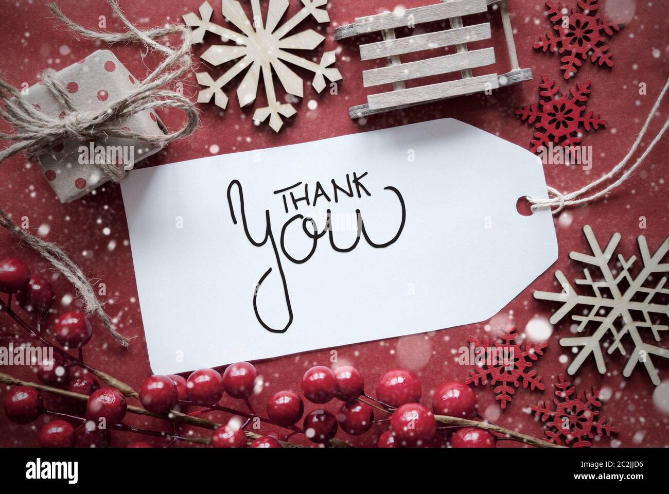 Una etichetta con la calligrafia inglese Grazie. Natale Rosso Deocration simili Sled, presente e Snowlfakes Foto Stock