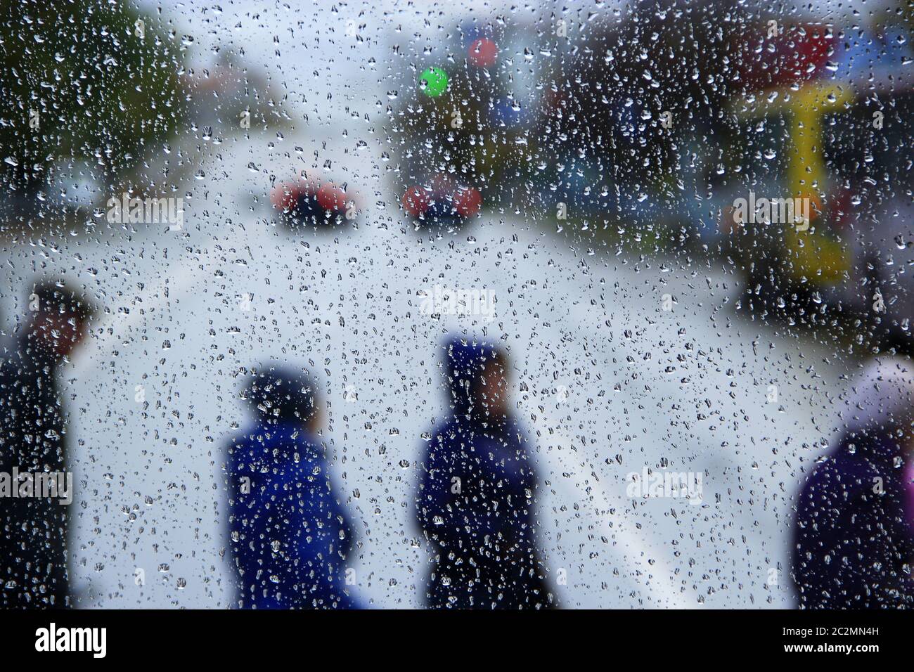 Pioggia fuori finestra sullo sfondo della vita della città. Gocce d'acqua che cadono sul vetro durante la pioggia Foto Stock