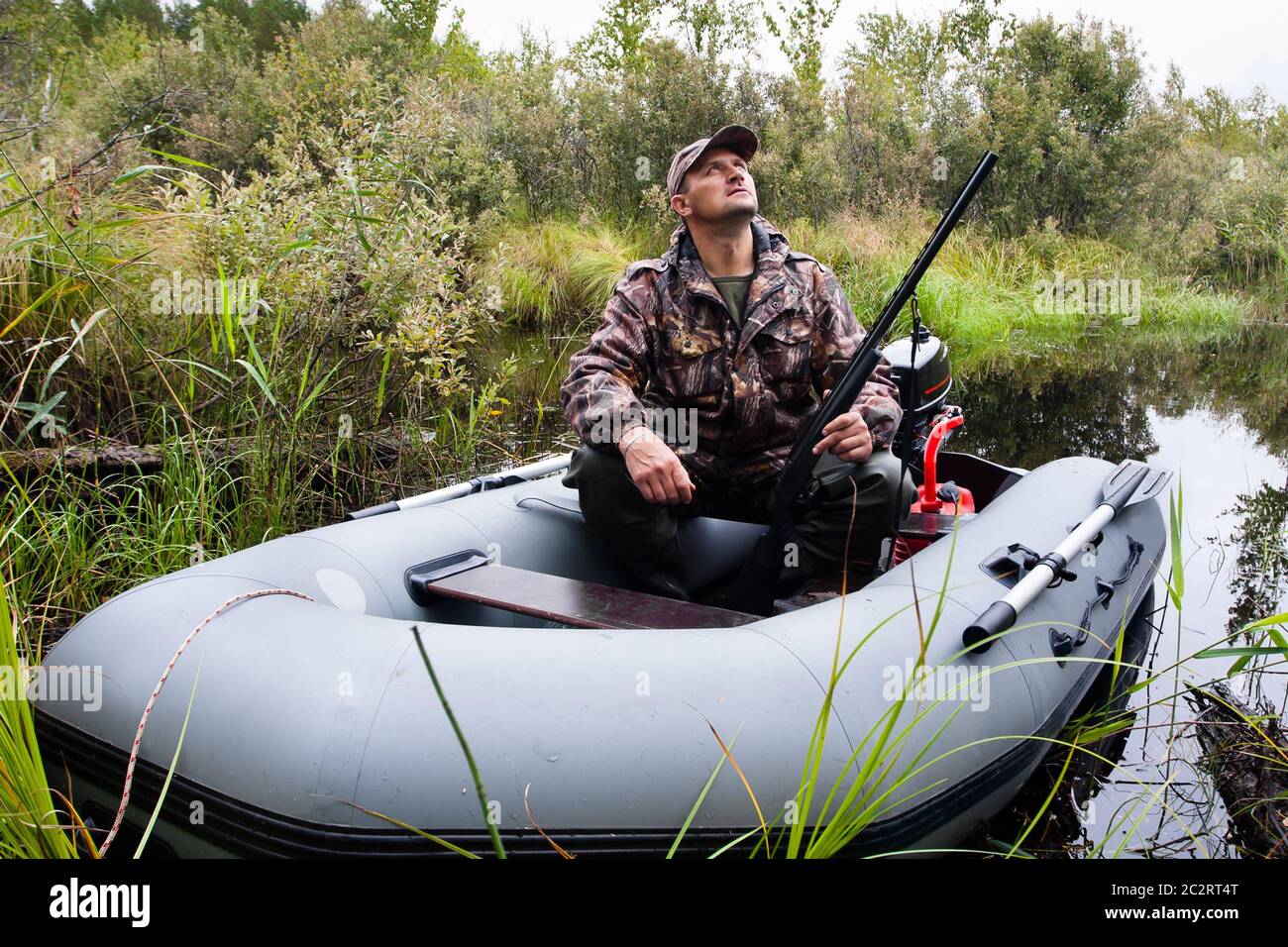 Hunter seduto in una barca a motore Foto Stock