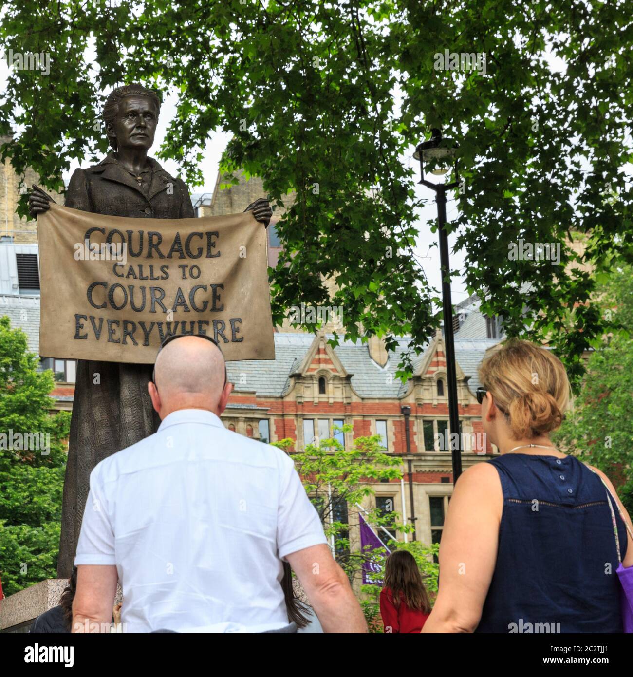 La gente guarda la statua di bronzo di Garrett Fawcett, attivista e suffragista dei diritti delle donne, Piazza del Parlamento, Londra Foto Stock