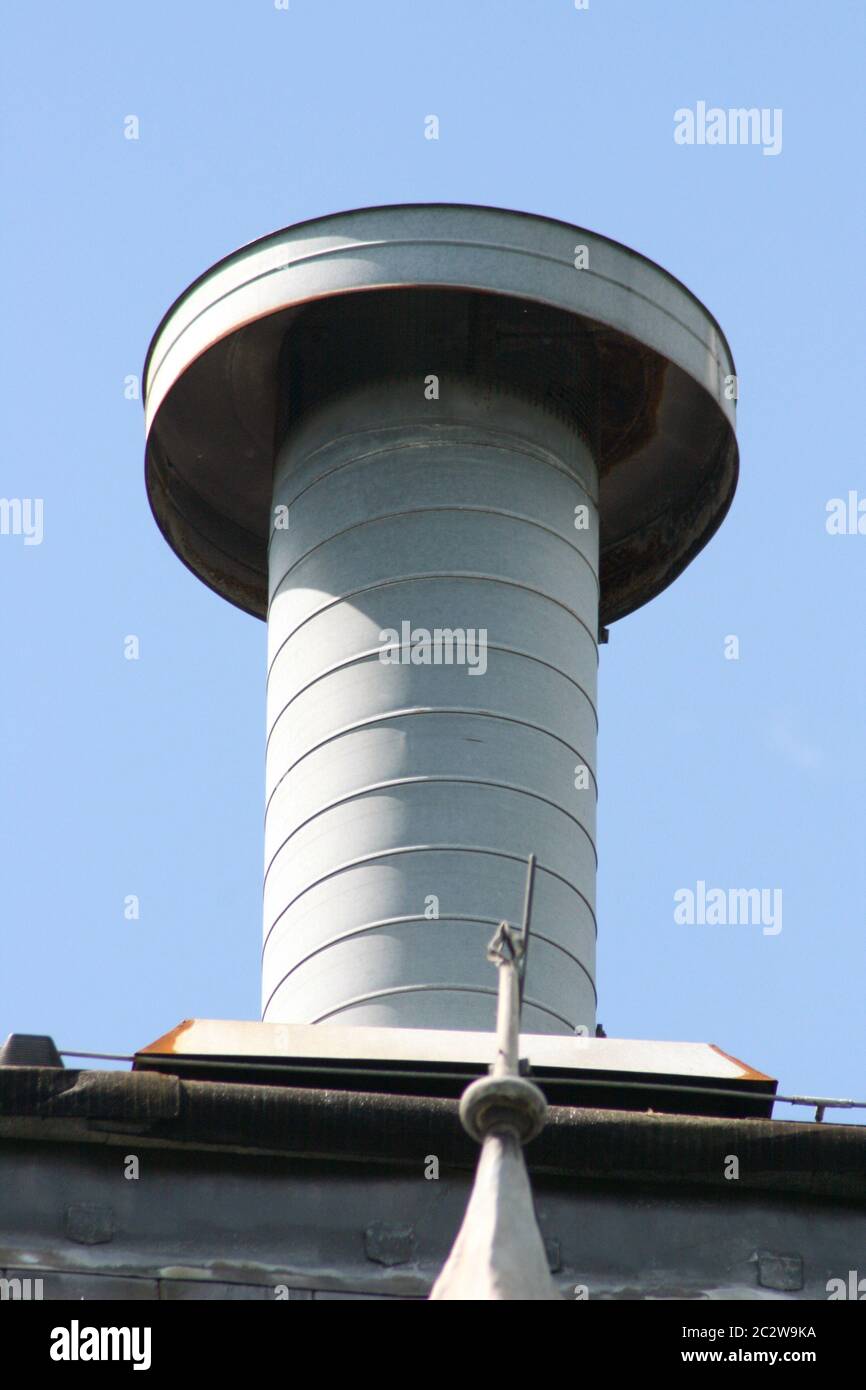 Tubazione di sfiato con il coperchio sulla parte superiore di un edificio Foto Stock