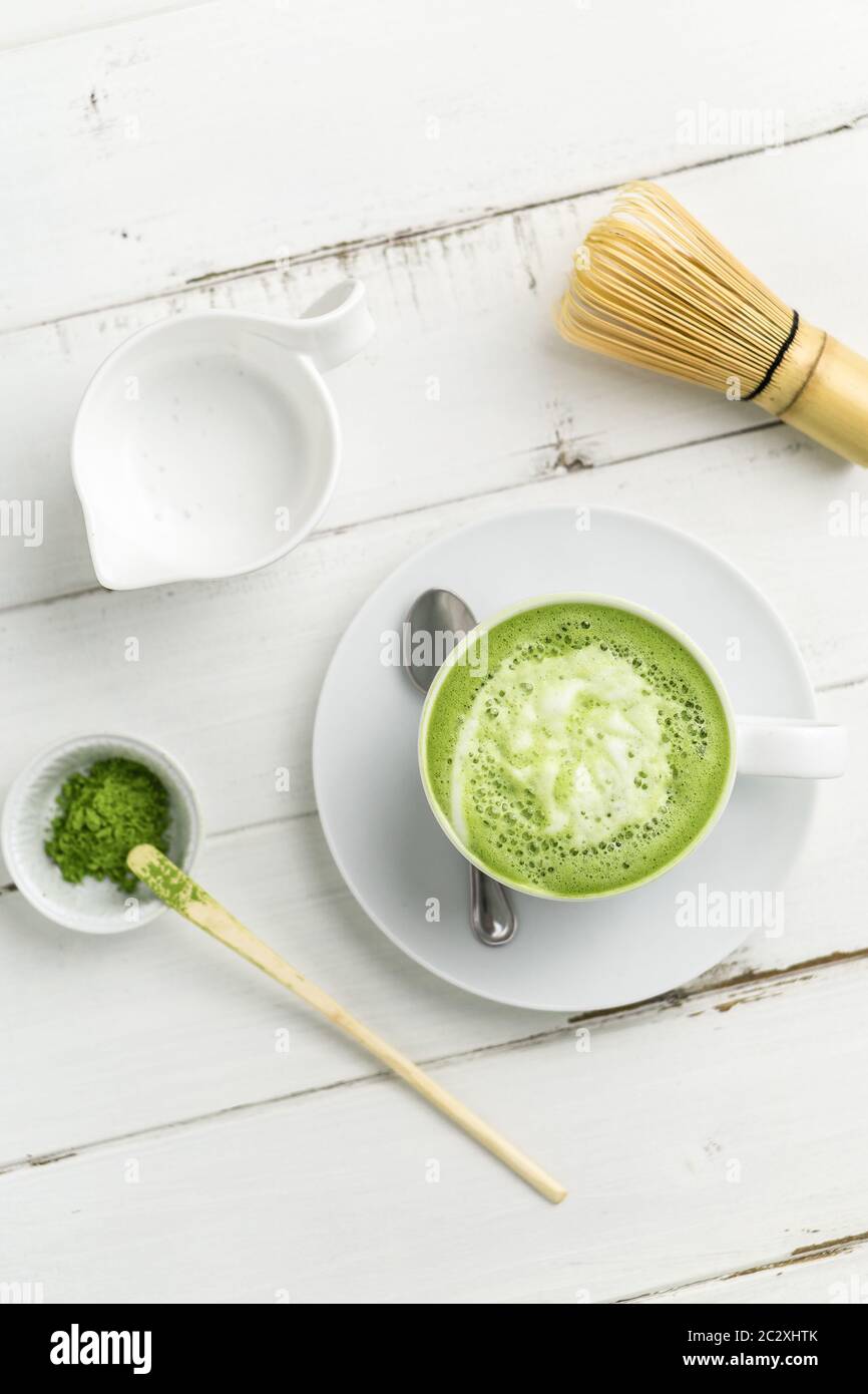 Tazza di latte di tè verde matcha su sfondo bianco. Questo latte è un modo delizioso per godere del potenziamento energetico e benefici sani di matcha. Foto Stock