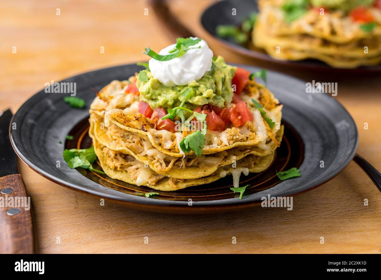 Stazzo croccante di pollo tostada. I tostadas sono un tipo di cibo messicano, fatto con tortillas croccanti di mais fritto ricoperte di strati di vari ingredienti. Foto Stock