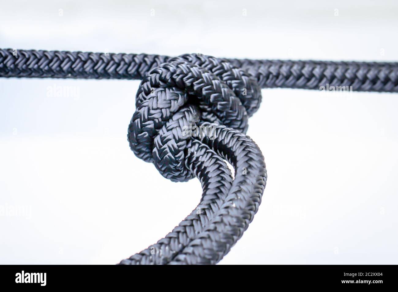 Una corda con un nodo, primo piano di un nodo nella corda Foto Stock