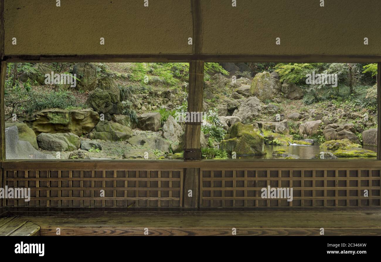 Casa da tè giapponese che si affaccia su una cascata e isolotti di pietra con muschio nello stagno di Rikugien parco g Foto Stock