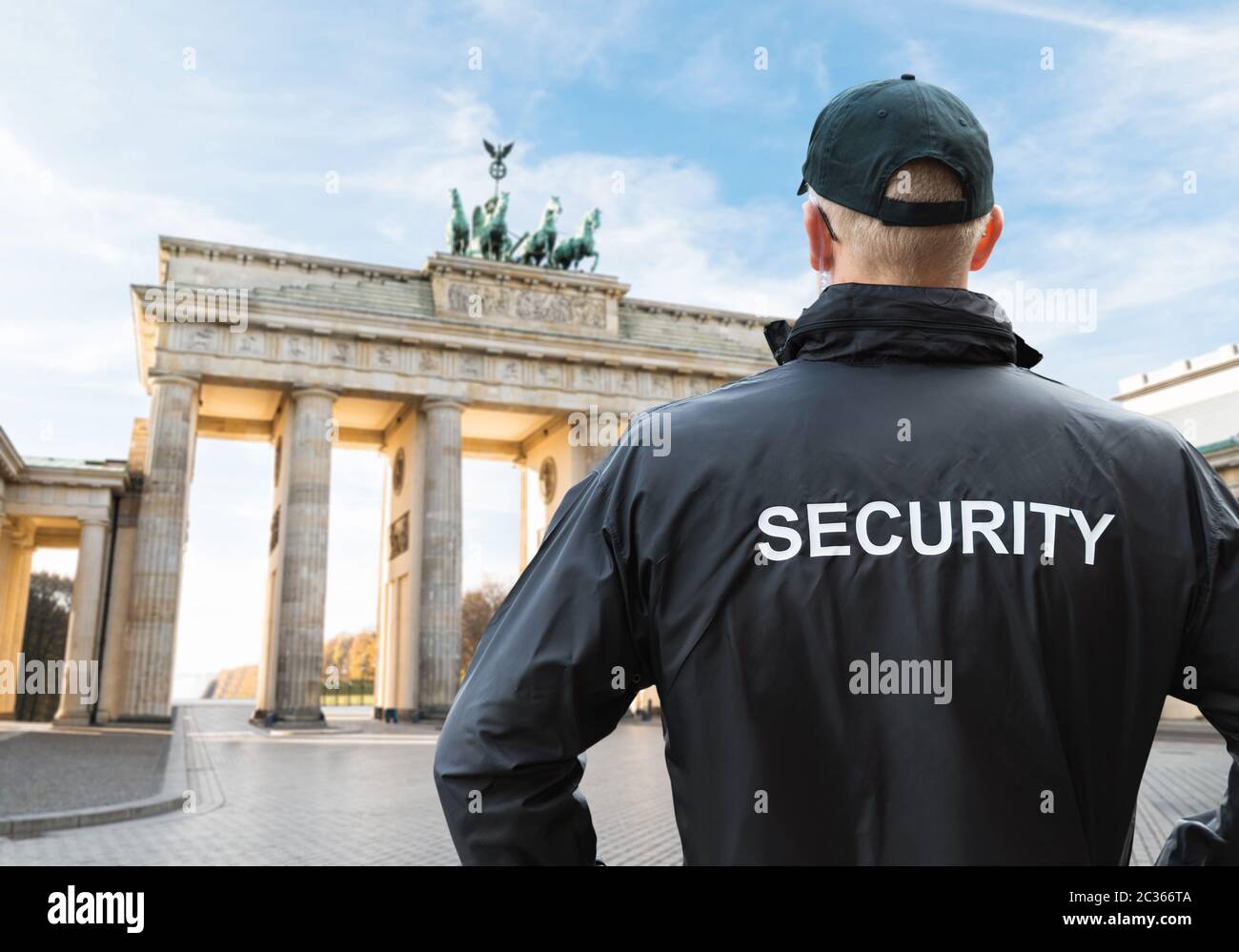 Senior Security Officer in piedi nella parte anteriore della porta di Brandeburgo, Berlino Foto Stock