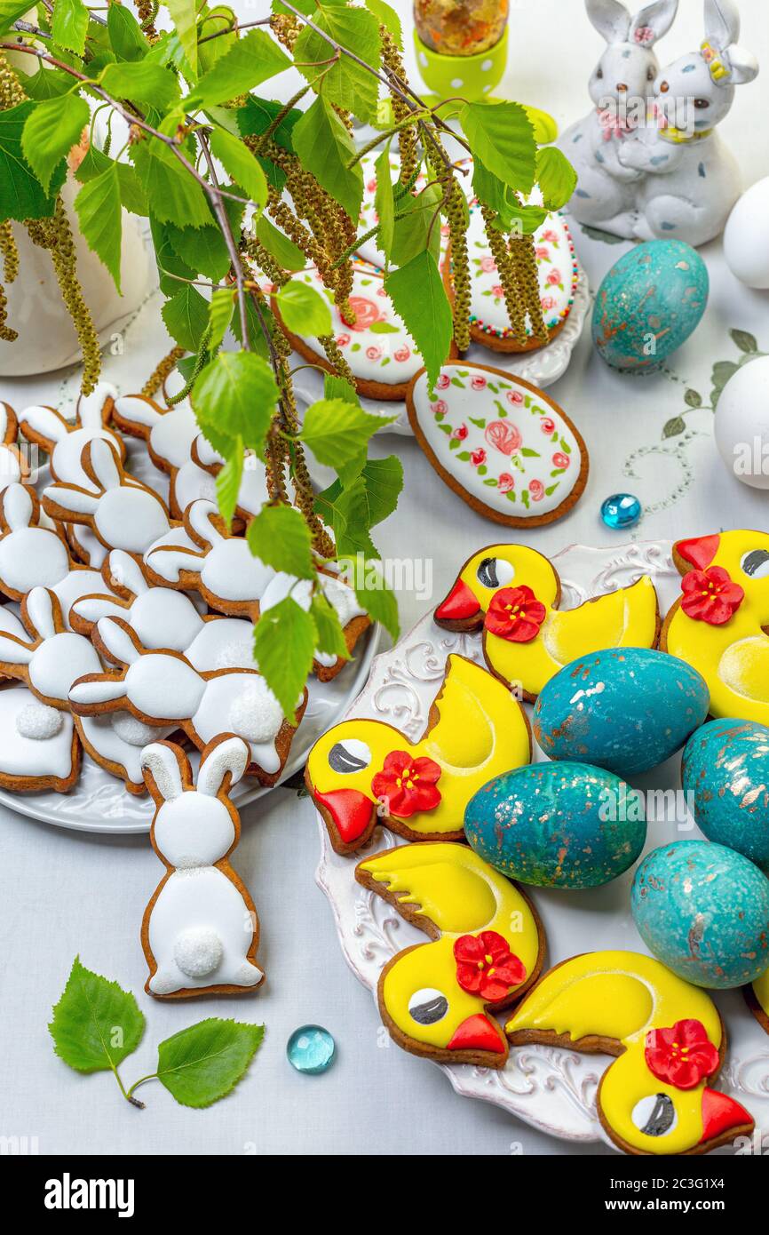 Tavolo festivo di Pasqua con biscotti sotto forma di anatre e coniglietti. Foto Stock