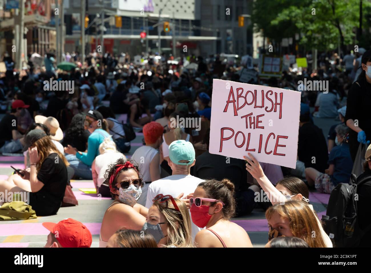 I manifestanti chiedono di abolire la polizia in un "Not another Black Life" sit-in lungo Toronto, Ontario's College e Bay Streets. Foto Stock
