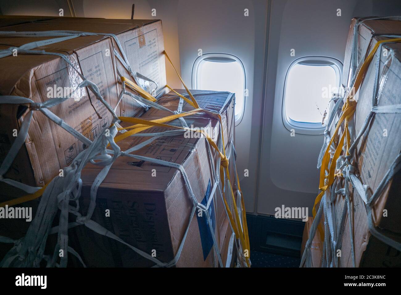 Vista interna di un passeggero convertito in aereo da carico Con scatole di maschere chirurgiche e camici dalla Cina a. Combattere la pandemia di COVID Foto Stock