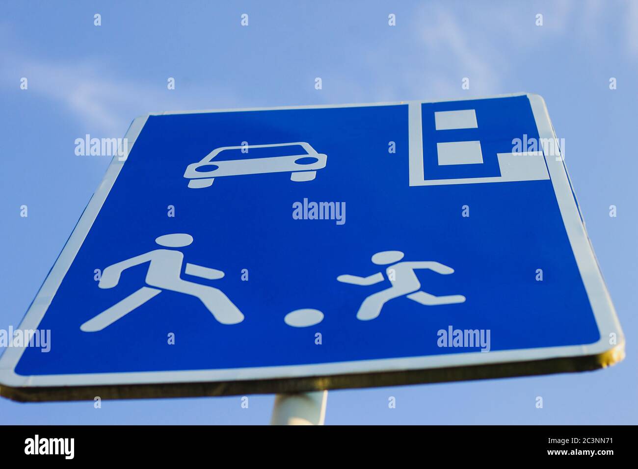 Cartello stradale informativo, scudo rettangolare blu con figure umane,  contrassegno auto e parcheggio su sfondo blu cielo. Attenzione, si  consiglia di zona pedonale Foto stock - Alamy