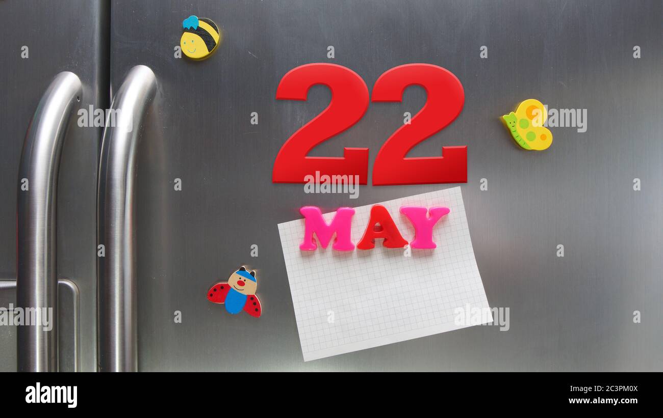 Data di calendario maggio 22 fatta con lettere magnetiche di plastica che tengono una nota di carta grafica sul frigorifero della porta Foto Stock