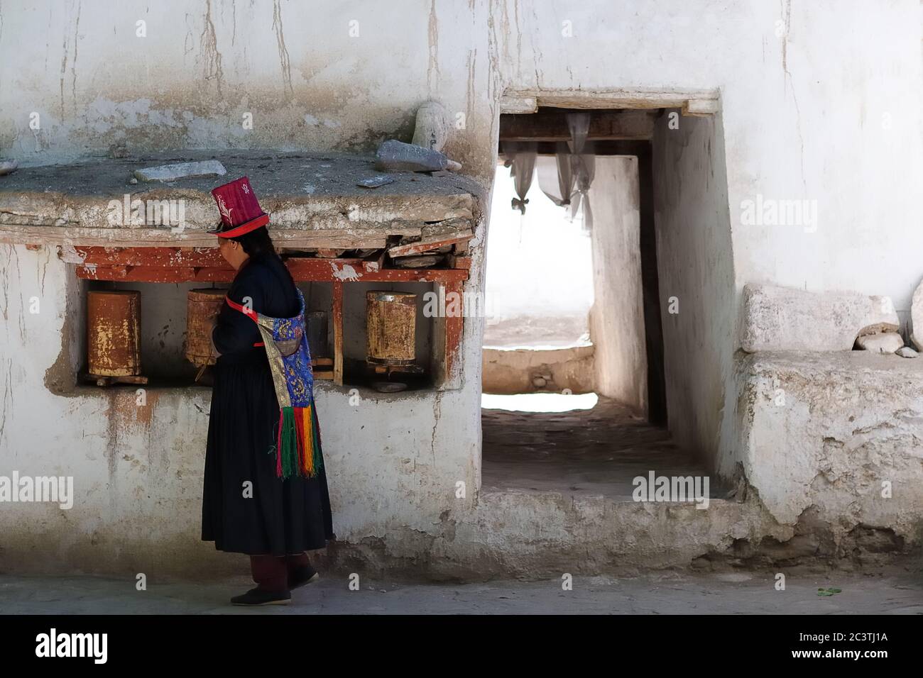 Alchi, India - 24 giugno: Donna ladakhi nel cappello tradizionale prima che il monastero di Alchi preghi, la valle dell'Indo il 24 giugno 2017 Foto Stock