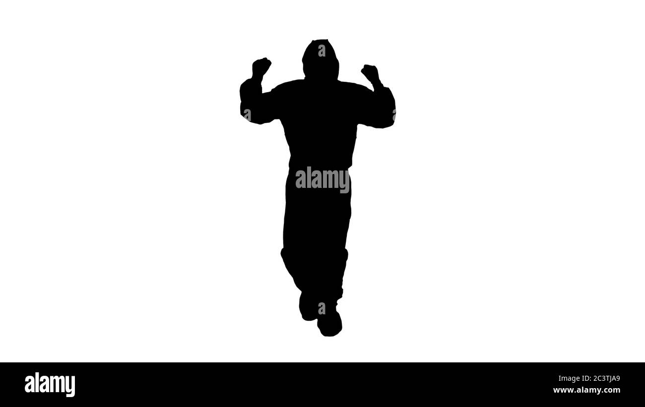 Silhouette uomo in costume da hazamat che cammina e balla. Concetto Covid-19. Foto Stock