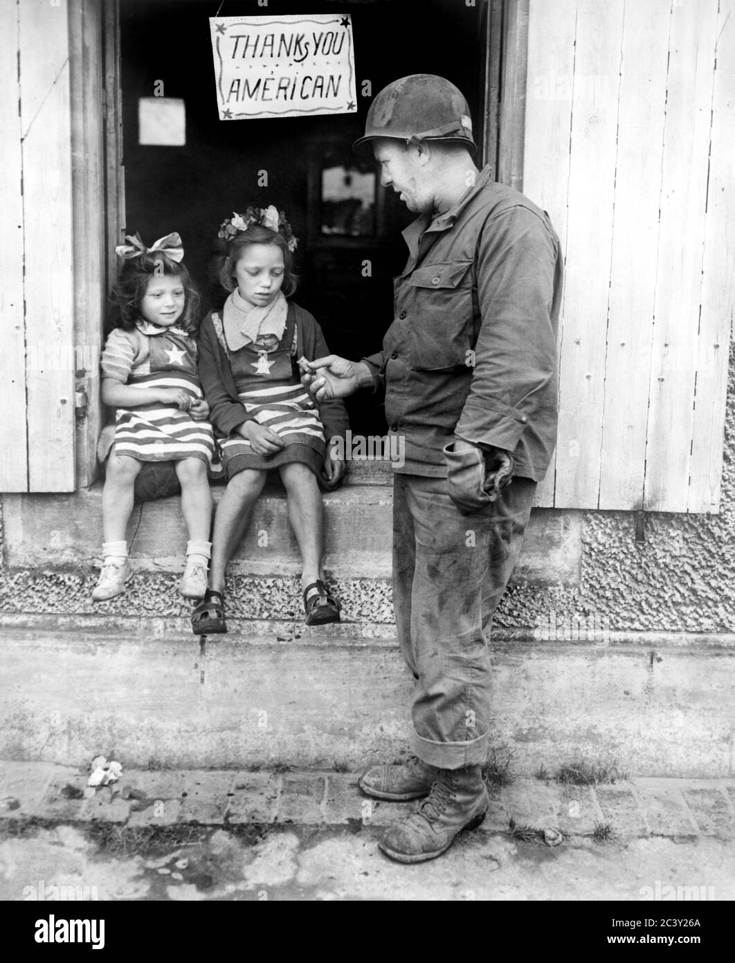 SGT. Walter P. Goworek, Jersey City, N.J., trattare due piccole ragazze francesi con Candy, Francia, corpo di segnale dell'esercito degli Stati Uniti, 4 luglio 1944 Foto Stock