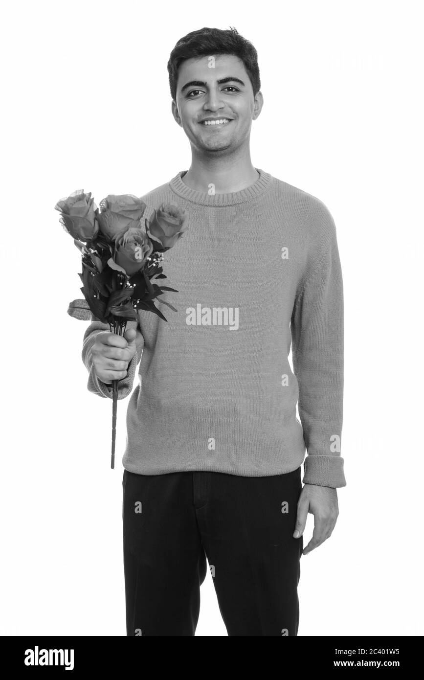 Giovani felici persiano di uomo con rose rosse pronto per il giorno di San Valentino Foto Stock
