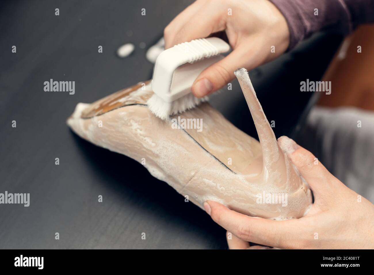 Concetto di cura delle scarpe in pelle. Pulizia e lucidatura dei pattini. Primo piano immagine delle scarpe da pulizia mani donna. Foto Stock