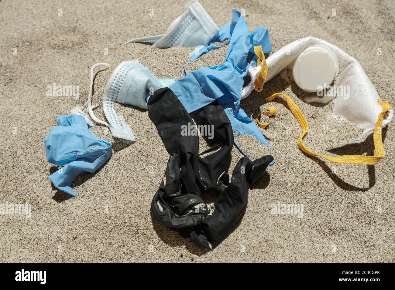 Maschera e guanti di plastica, rifiuti medici monouso sulla costa del mare, inquinamento covidio Foto Stock