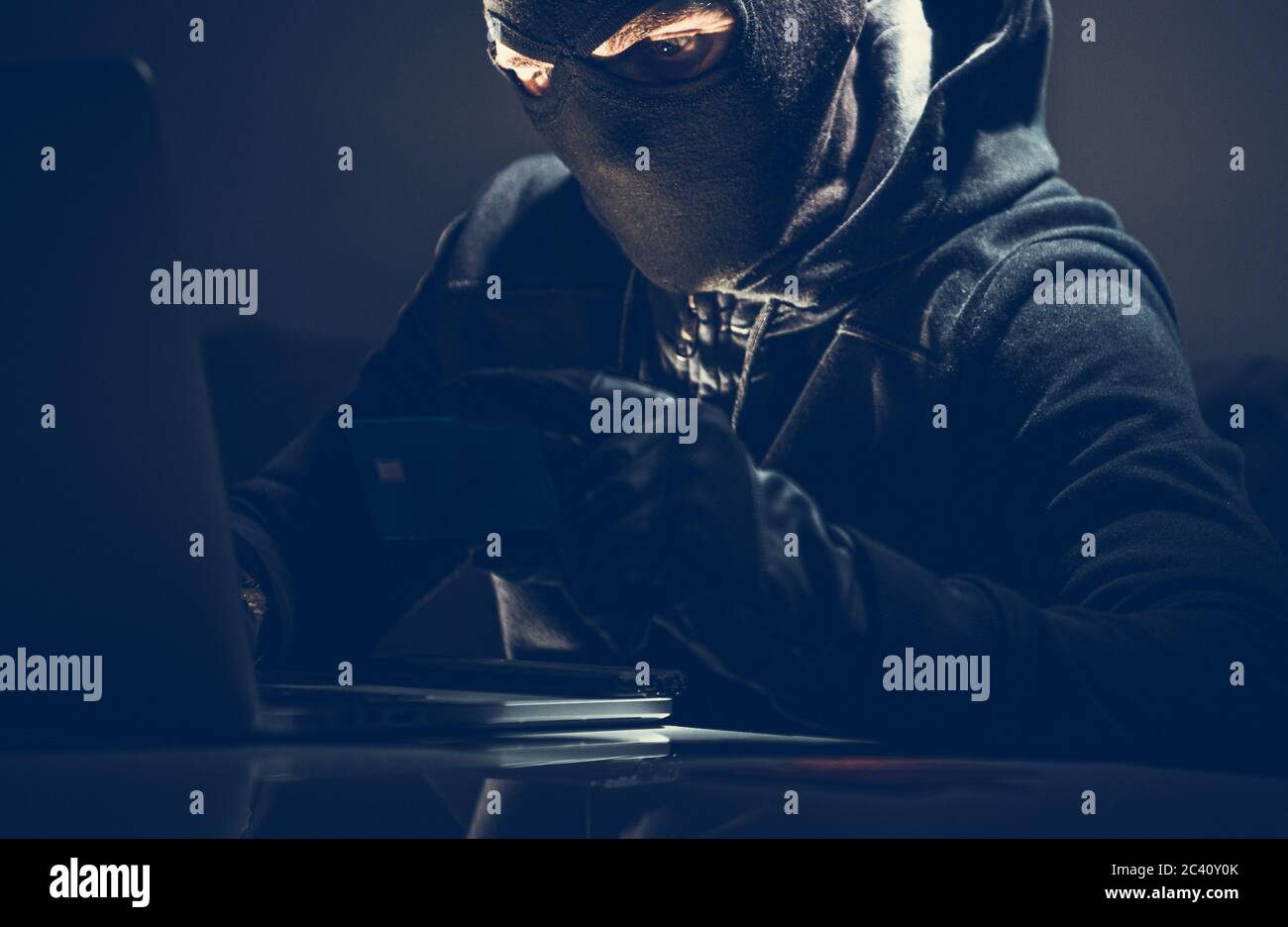 Acquisti online mascherati con Hacker e carte di credito rubate. Concetto di sicurezza informatica. Foto Stock