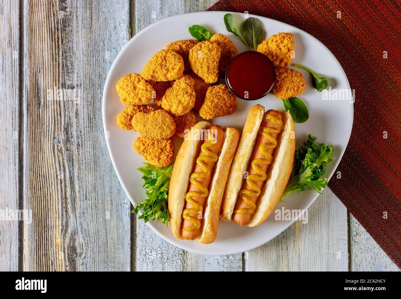 Concetto di fast food. Hot dog e pepite di pollo con ketchup. Foto Stock