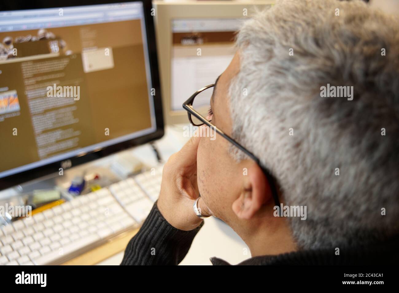 Uomo guarda lo schermo del computer Foto Stock