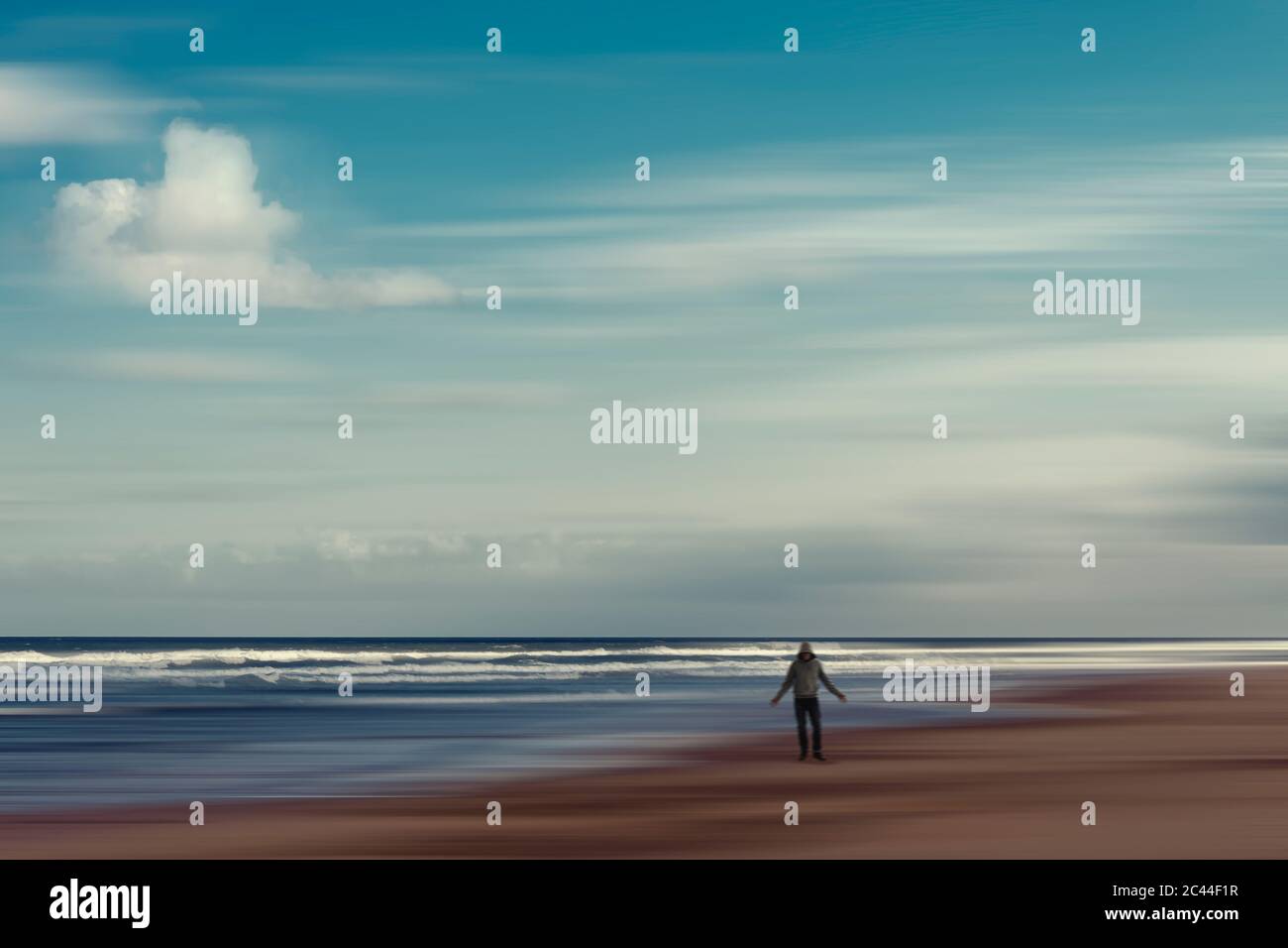 Francia, Nouvelle-Aquitaine, Contis, nuvole su uomo agganciato in piedi sulla spiaggia di Contis Plage Foto Stock