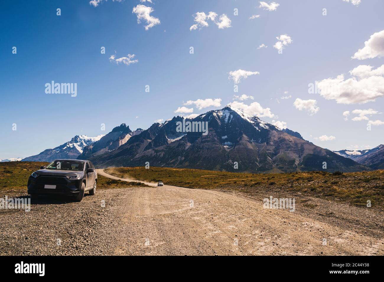 Cile, Auto parcheggiata accanto alla strada sterrata nel Parco Nazionale Torres del Paine Foto Stock