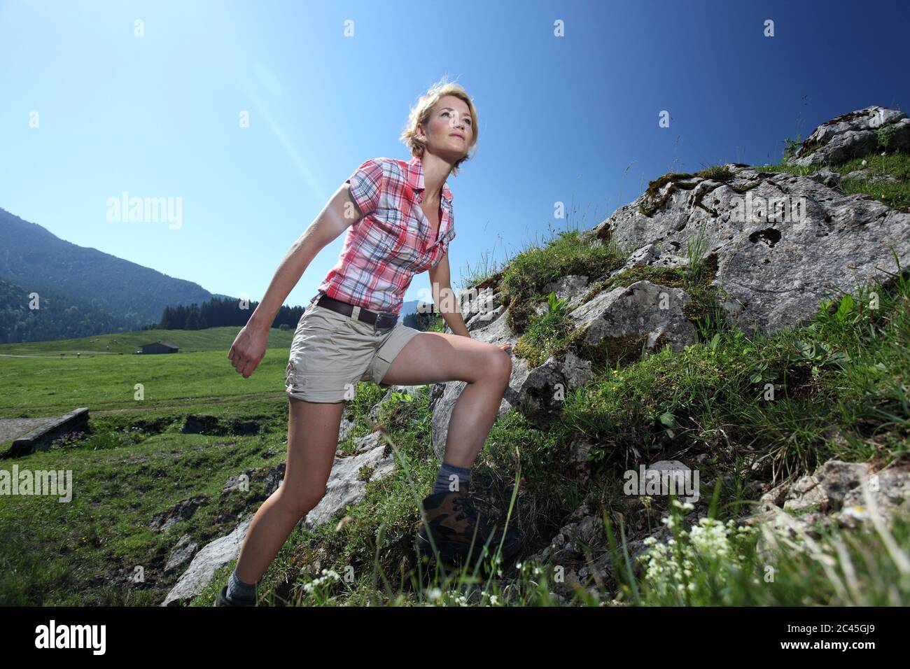 Donna sale su una collina, Spitzingsee, Baviera, Germania Foto Stock