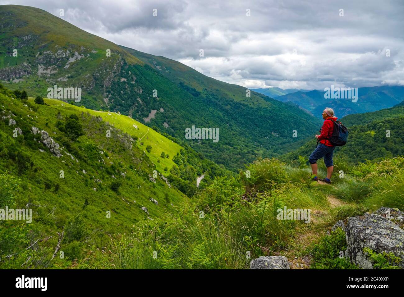 Donna escursionista in rosso vicino al Port de Lers, un passo di montagna in Ariege, Pirenei, Francia Foto Stock