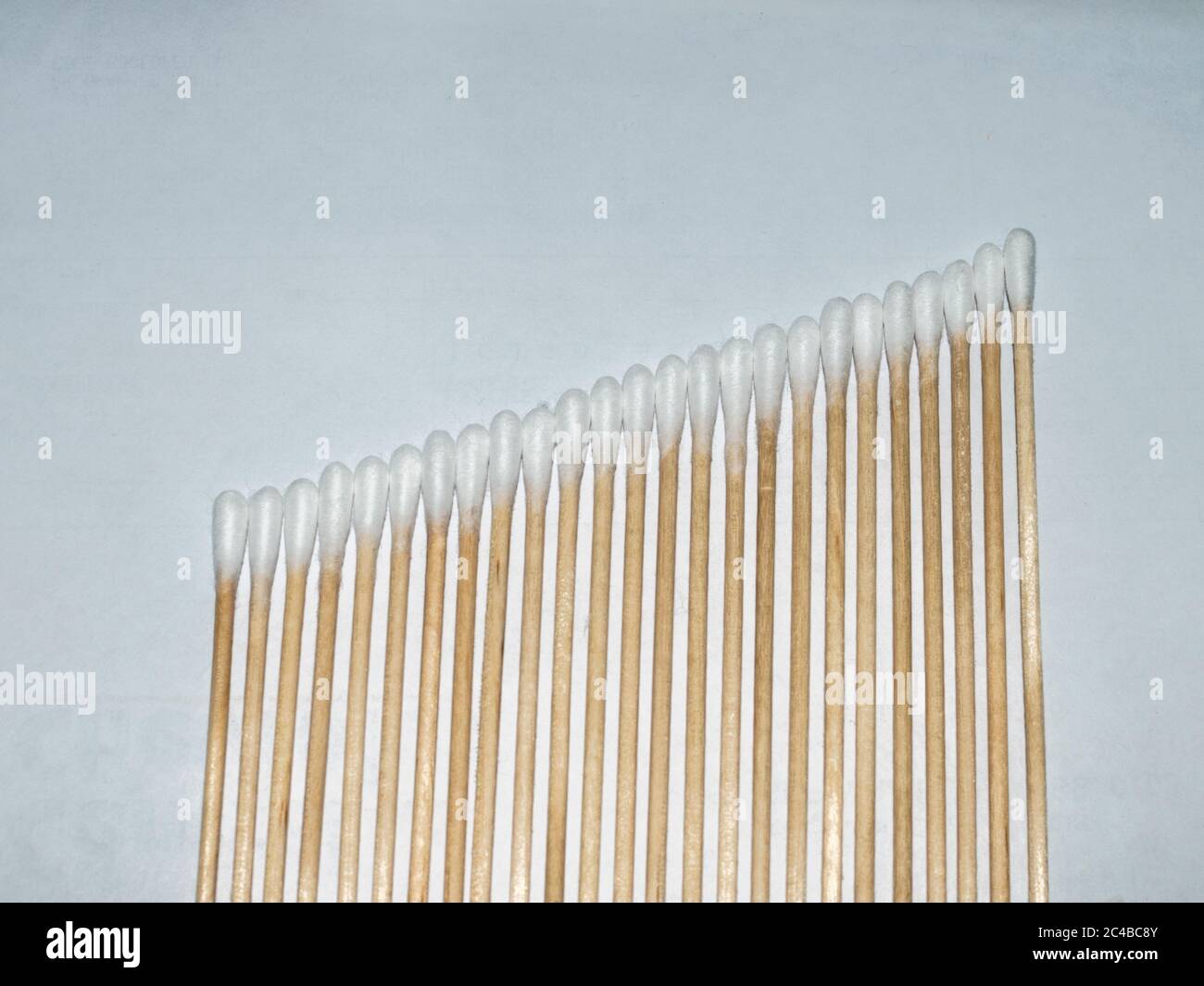 Linea diagonale di tamponi in cotone bianco ad altezza crescente Foto Stock
