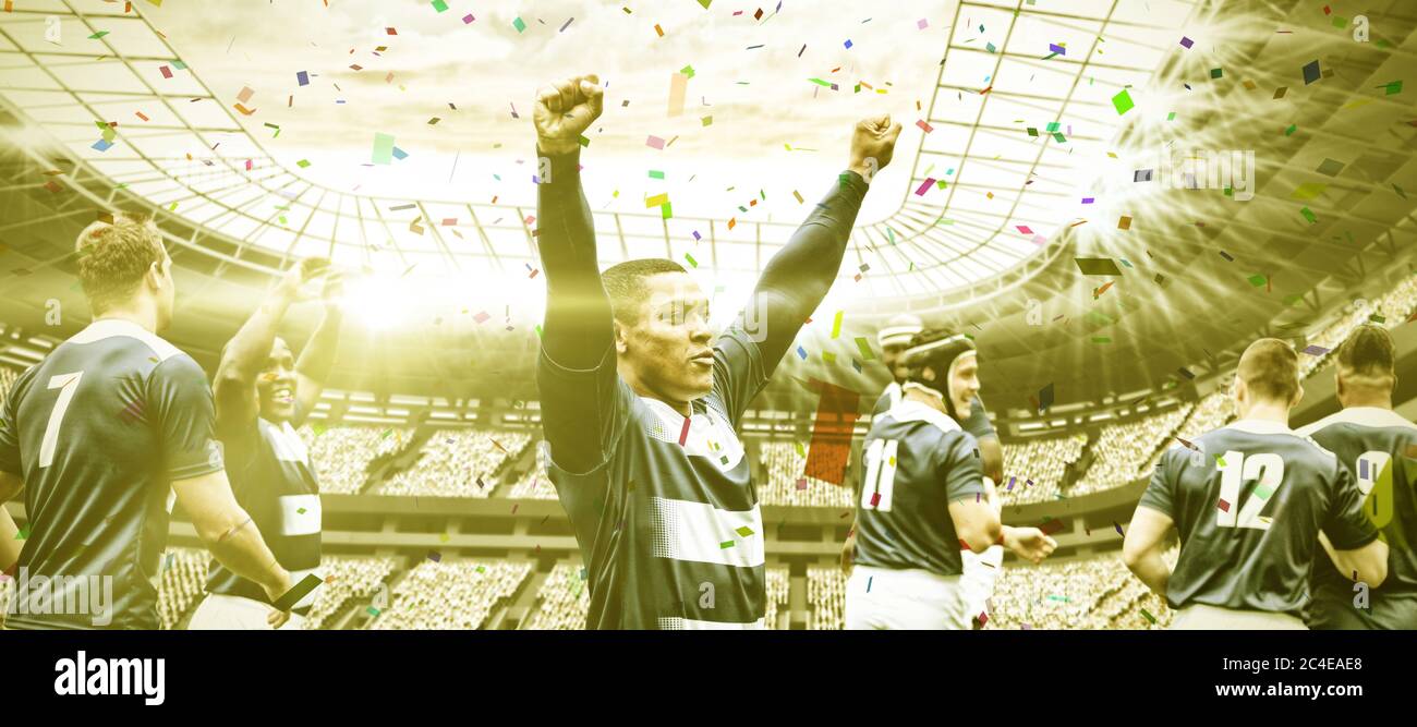 Immagine digitale composita della squadra di rugby che celebra una vittoria nello stadio sportivo Foto Stock
