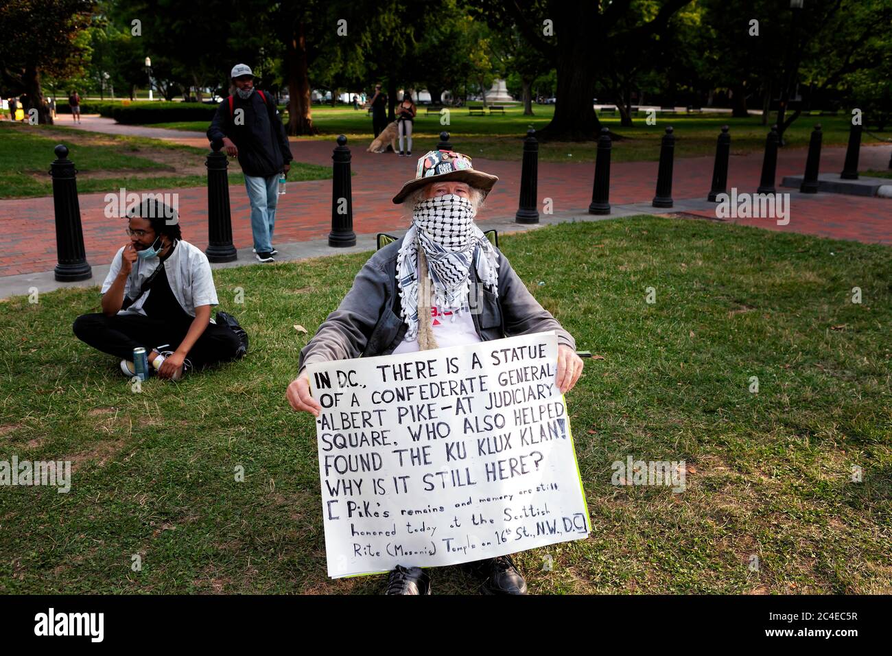 Il protester tiene un segno che chiede perché la statua di Albert Pike ancora si trova in DC, Black Lives Matter Plaza / Lafayette Square, Washington, DC, Stati Uniti Foto Stock